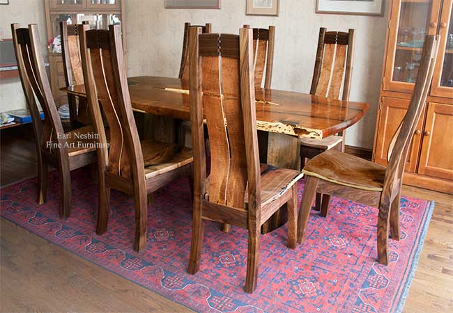 unique live edge table with all eight chairs installed from other end